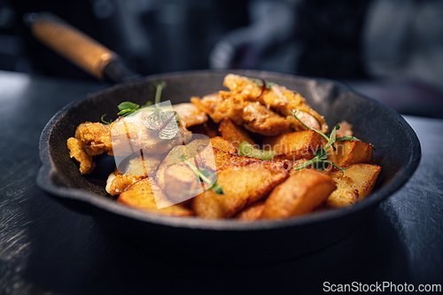 Image of Fried potato wedges with schnitzel