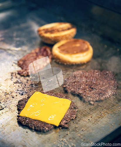 Image of Cooking burgers on hot grill