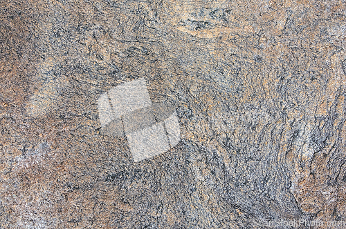 Image of Detailed close up view of a textured granite surface, showcasing the intricate patterns and colors found in the natural stone.