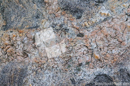 Image of Detailed look at the natural patterns and colors of a granite rock surface.