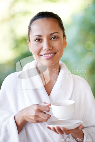Image of Woman, relax and portrait at spa with coffee, hotel and bathrobe from wellness and skincare treatment. Espresso, happy and smile from tea cup and health with hospitality at lodge with luxury and care