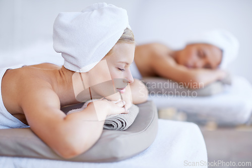 Image of Women, spa and relax lying on table for skincare, beauty and luxury treatment for wellness. People, rest and calm person on bed in salon or hotel for massage or dermatology care with zen or peace