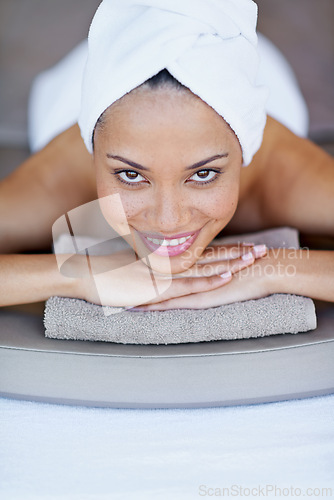 Image of Spa, woman and happy on massage bed with portrait for wellness, zen and beauty treatment for body care. Person, face and physical therapy at resort, salon table and relax on holiday or vacation
