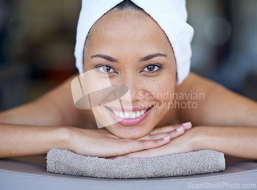 Image of Spa, woman and portrait on massage bed with smile for wellness, zen and beauty treatment for body care. Person, relax and physical therapy at resort, salon table and luxury on holiday or vacation