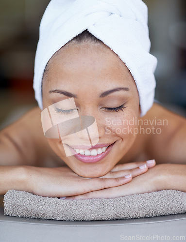 Image of Spa, woman and relax on massage bed with smile for wellness, zen and beauty treatment for body care. Person, sleeping and physical therapy at resort, salon table and luxury on holiday or vacation