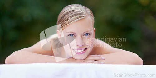 Image of Spa, woman and happy on massage bed with portrait for wellness, zen and beauty treatment for body care. Person, relax and physical therapy at resort, salon table and luxury on holiday or vacation