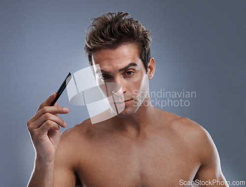 Image of Man, portrait and comb hair for style or grooming on grey background for hygiene, self care and shirtless. Male person, model and face with brush for routine in morning, confidence or mockup space