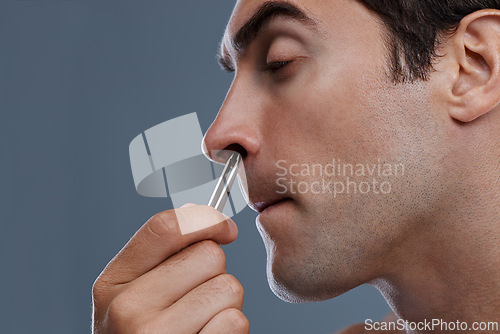 Image of Nose hair, cleaning and man with tweezers and pain from plucking in studio background or mockup. Beauty, epilation and person with facial grooming routine and treatment for self care with tools