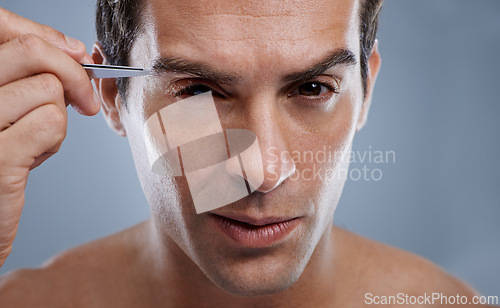 Image of Man, portrait and tweezers for eyebrows or grooming for face clean, hygiene or grey background. Male person, pluck and hair removal for healthy morning routine or studio, treatment or mockup space