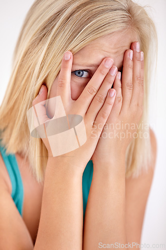 Image of Scared, portrait and woman with hands on face, fear and confused with trauma in horror studio. Panic, scary danger and shocked embarrassed girl with stress, anxiety and terror on white background.