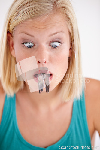 Image of Shocked, woman and eating of fish with surprise on face in white background of studio. Crazy, diet and hungry person with horror at weird seafood, cuisine and disgust in mouth for gross food