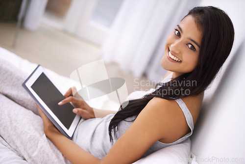 Image of Portrait, tablet and woman with a smile, screen and relax with online news, internet and connection. Home, person or girl with technology, apartment and website info with social media and digital app