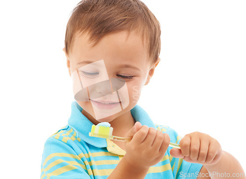 Image of Boy child, toothpaste and toothbrush in studio with smile for health, cleaning and hygiene by white background. Kid, thinking and happy for choice, learning and brushing teeth for dental wellness