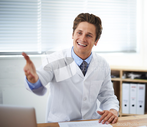 Image of Handshake, smile and man doctor in office for greeting hello at a medical consultation at clinic. Happy, professional and young male healthcare worker with shaking hand gesture in a medicare hospital