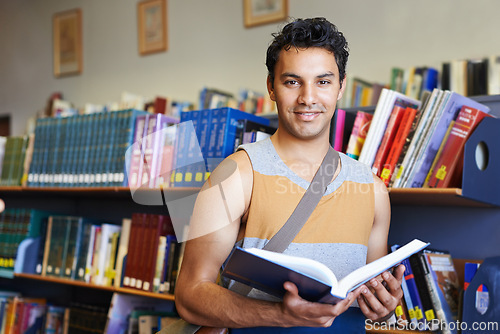 Image of Reading book, portrait or happy man in library at university, college or school campus for education. Bookshelf, learning or male student with scholarship studying knowledge, research or information