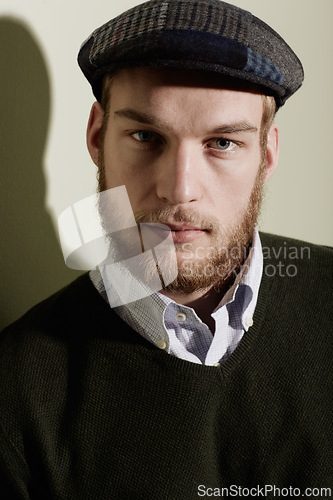 Image of Fashion, serious and portrait of man with style, trendy clothes and cool outfit on wall background. Aesthetic, model and face of attractive person with pride, confidence and handsome in studio