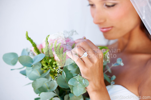 Image of Bridal, wedding and woman with flowers, veil and engagement ring for marriage ceremony. Jewelry, beauty and young bride with makeup face and floral bouquet for elegant, romantic and love reception.