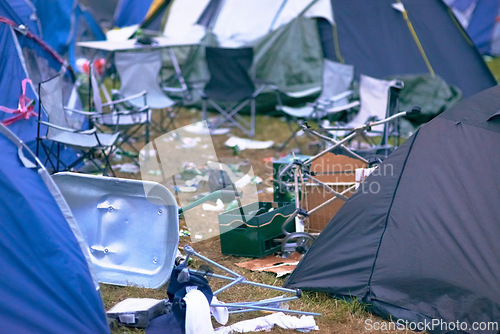 Image of Tents, trash and mess at an outdoor music festival or event for a celebration party or social gathering. Summer, campsite and dirty with untidy camping gear, chairs or cooler boxes on the ground