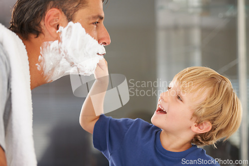 Image of Help with shaving, dad and child with cream on face, smile and bonding in home with morning routine. Teaching, learning and father with happy son in bathroom for shave, clean fun or grooming together