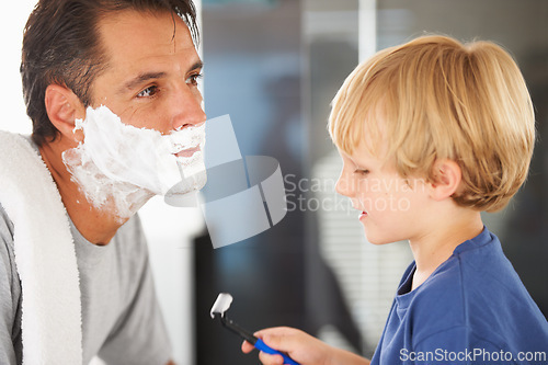 Image of Help with shaving, father and child with cream on face, smile and bonding in home with morning routine. Teaching, learning and dad with happy son in bathroom for love, clean fun or grooming together