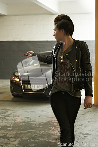 Image of Woman, parking and lock car with cool punk style in garage for safety at home. Underground, vehicle and female person with button for security with edgy fashion and driving trasnportation and trip