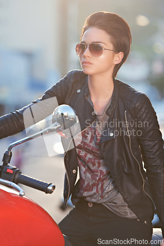 Image of Motorcycle, leather and biker in city with sunglasses for travel, transport or road trip as rebel. Fashion, street and woman with attitude on classic or vintage bike for transportation or journey