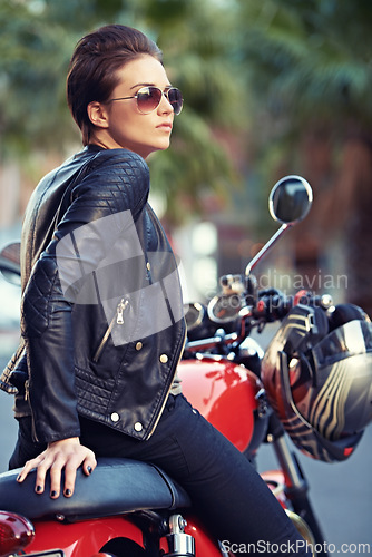 Image of Motorcycle, road trip and woman thinking in city with sunglasses for travel or transport as rebel. Fashion, street and person with attitude on classic or vintage bike for transportation or journey