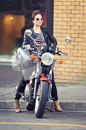 Image of Motorcycle, leather and woman on street with sunglasses for travel, transport or road trip as rebel. Fashion, city and model with attitude on classic or vintage bike for transportation or journey