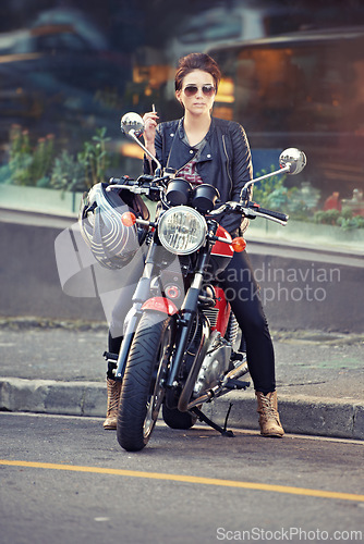 Image of Motorcycle, leather and woman in city with cigarette for travel, transport or road trip as rebel. Fashion, street and smoke with model on classic or vintage bike for transportation or journey