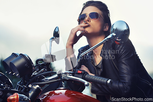 Image of Bike, leather and woman smoking in city with sunglasses for travel, transport or road trip as rebel. Fashion, model and nicotine with attitude on classic or vintage bike for transportation or journey
