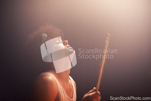 Image of Man, drummer and musician in performance at rock concert, music festival on stage and talent. Person, artist and play on drumstick for entertainment, sound and rehearsal on percussion instrument