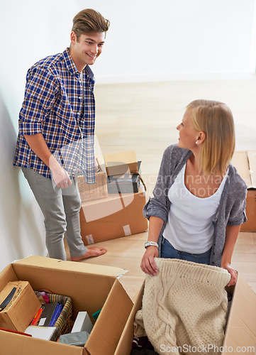 Image of Man, woman and packing boxes for moving to new home or property investment, real estate or mortgage. Couple, happy and apartment ownership or relocation organize for marriage beginning, buy or rent
