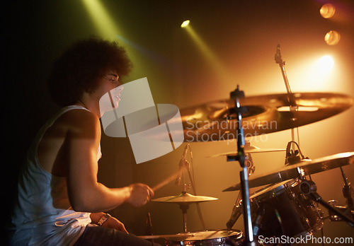 Image of Stage, performance and man on drums at concert playing jazz, beat and talent for music. Drummer, musician and creative person in theater with rhythm for percussion, instrument or show at night