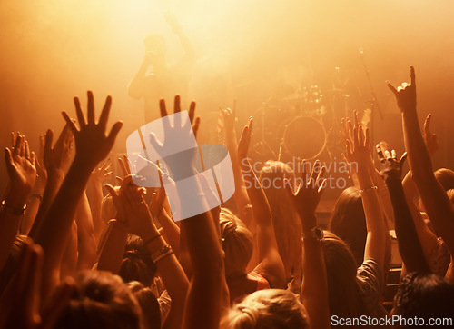 Image of Music, concert and group of fans for performance with lighting equipment at party or rave. Event, entertainment and audience at festival, disco or club with energy for crowd for song at venue.