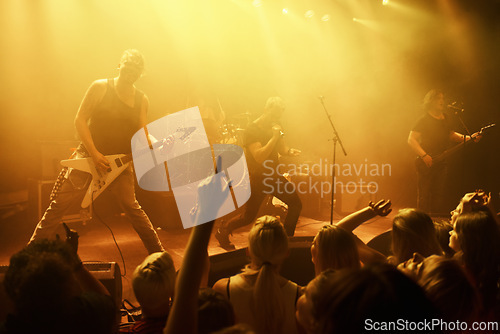 Image of Music, concert and band on a stage with audience for performance with lighting equipment at party. Event, entertainment and group of musicians at festival, disco or rave with energy for crowd or fans