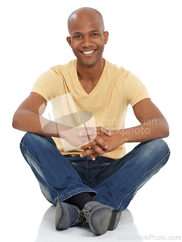 Image of Fashion, portrait and happy black man on a studio floor with good mood, confidence and positive attitude on white background. Face, smile and African male model with casual, clothes or streetwear
