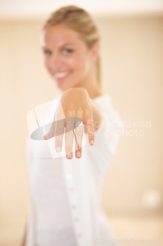 Image of Woman, hands and wedding ring with engagement announcement and diamond sparkle. Marriage, female person and love with jewelry band, proposal and fiance with a smile and happy from commitment