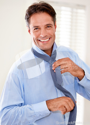 Image of Portrait, tie and happy businessman dressing in home, job or entrepreneur preparation in the morning. Face, professional and getting ready for working, person tying necktie and consultant in house