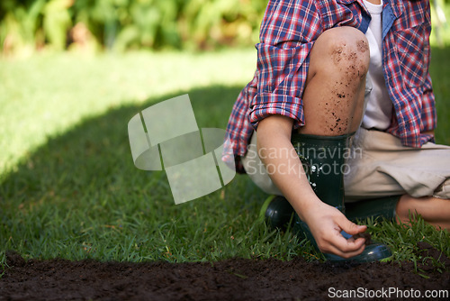 Image of Legs, hands and child gardening with soil in nature for ecology and development education. Kid, dirt and planting in yard and playing in backyard for environmental landscaping in summer leisure