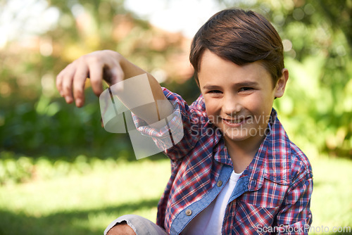 Image of Boy, smile and portrait holding a worm in a garden for fun learning, development and growth. Curious, happy and young male person with a bug animal in nature for ecology education in environment