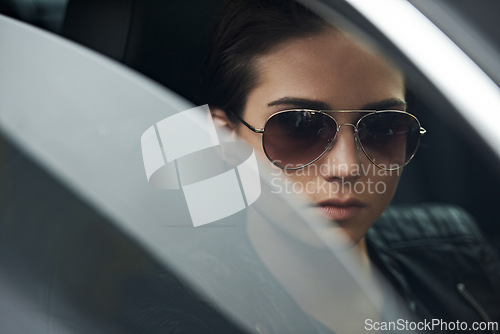 Image of Window, car and face of woman with sunglasses for cool style and accessory while driving on a trip. Edgy, trendy and eyewear with a fashionable female person in a transport vehicle for journey
