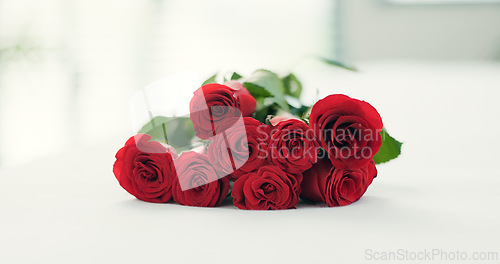 Image of Romance, flowers and roses on bed for love on valentines day, anniversary celebration and honeymoon. Red rose, bouquet and closeup of florals in bedroom for romantic date, occasion and luxury in home