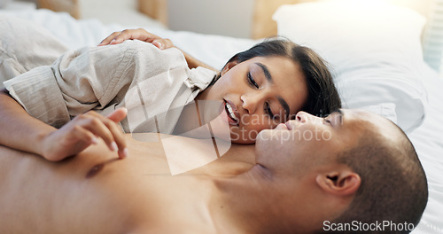 Image of Happy couple, bed and talking of love, intimacy and romance at home for relationship and bonding. Young woman and man hug and relax in bedroom for marriage, kiss and wake up together in apartment