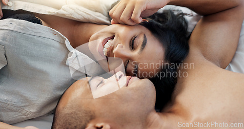 Image of Happy couple, relax and bed for morning, romance or love in embrace, trust or care above at home. Young man and woman smile lying in bedroom rest for intimacy, passion or bonding together at house