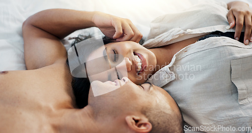 Image of Happy couple, bed and talking of love, intimacy and romance at home for relationship and bonding. Young woman and man hug and relax in bedroom for marriage, kiss and wake up together in apartment