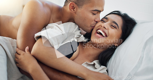 Image of Happy couple, hug in bed and love with intimacy and romance at home for relationship, sex and bonding. Young people, woman and man relax in bedroom, cuddle and laughing with kiss and talking together