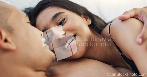 Image of Couple, hug and loving conversation in bed on sunday morning, bonding and hugging on weekend. People, embrace and communication in relationship at home, kiss and resting or greeting for waking up