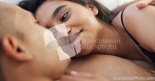 Image of Couple, hug and loving conversation in bed on sunday morning, bonding and hugging on weekend. People, embrace and communication in relationship at home, kiss and resting or greeting for waking up