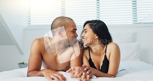 Image of Happy couple, relax and kissing on bed for affection, morning romance or love in embrace, trust or care at home. Young man and woman smile lying in bedroom for intimacy, passion or bonding at house