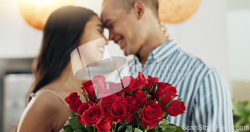 Image of Couple, flowers and kiss for anniversary celebration, marriage and loyalty or commitment to love. People, happy and romance for relationship milestone, bonding and plant gift for support at home